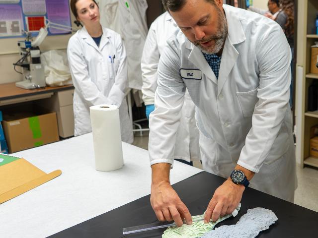 UC Davis Forensic Science lecturer Philip Hess measures footwear impressions