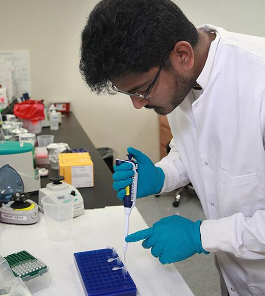 Anutham Raghav, a graduate of the UC Davis Forensic Science M.S. program, in the lab pipetting