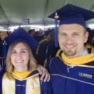 UC Davis Forensic Science graduate Shane Williams and fellow alumni in cap and gown at graduation